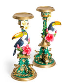 Decorative candle holders with toucan and floral designs on a white background