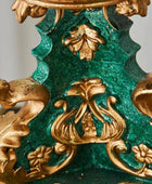 Decorative object with gold and green intricate design on a gray background