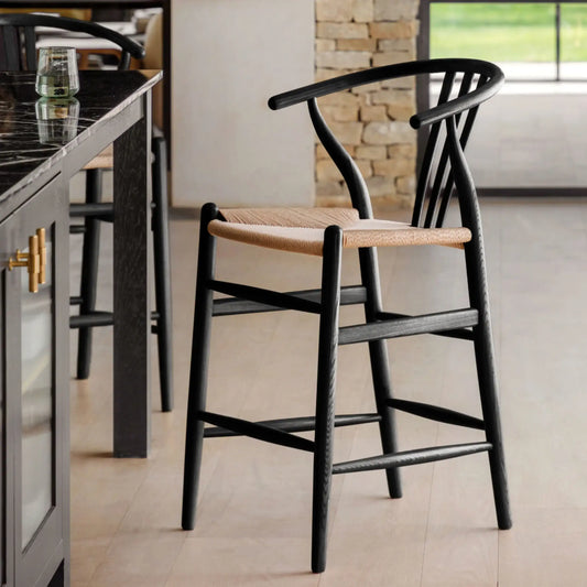 Black bar stools with woven seats in a kitchen setting