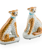 Two ceramic cheetah figurines on a white background