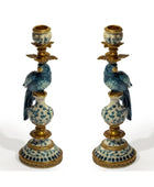Pair of decorative candle holders with blue and white designs on a white background