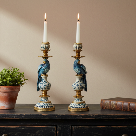 Two decorative candle holders with parrot designs on a wooden surface.