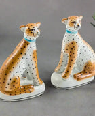 Two ceramic cheetah figurines on a white background
