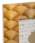 Decorative gold shell patterned frame with a piece of paper inside