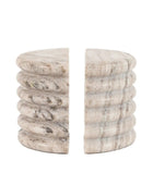 Marble-textured cylindrical bookends on a white background