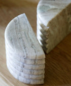 Marble-like stone coasters on a wooden surface