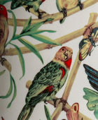 Illustration of birds and butterflies on a branch with leaves