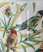 Decorative tile with parrot and butterfly design on a white background