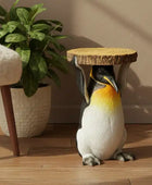 Penguin-shaped stool with a cork top on a wooden floor next to a plant