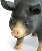 Statue of a pig with a detailed face on a white background