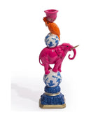 Decorative figurine with pink elephant, orange parrot, and blue and white ball on a white background