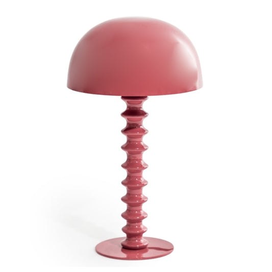 Pink table lamp with a unique base design on a white background