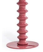 Pink candle holder with a geometric design on a white background