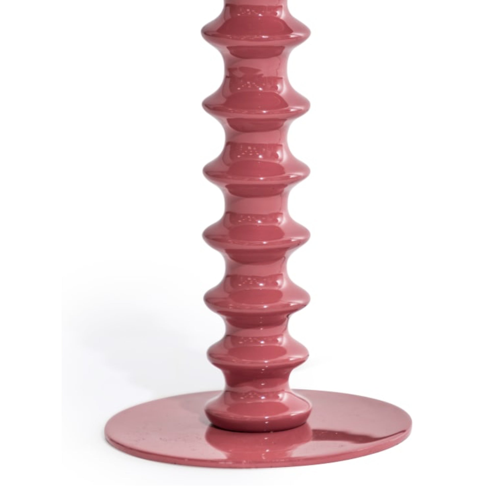 Pink candle holder with a geometric design on a white background