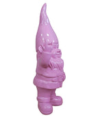 Pink garden gnome against a stone wall background