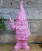Pink garden gnome figurine with a stone wall background