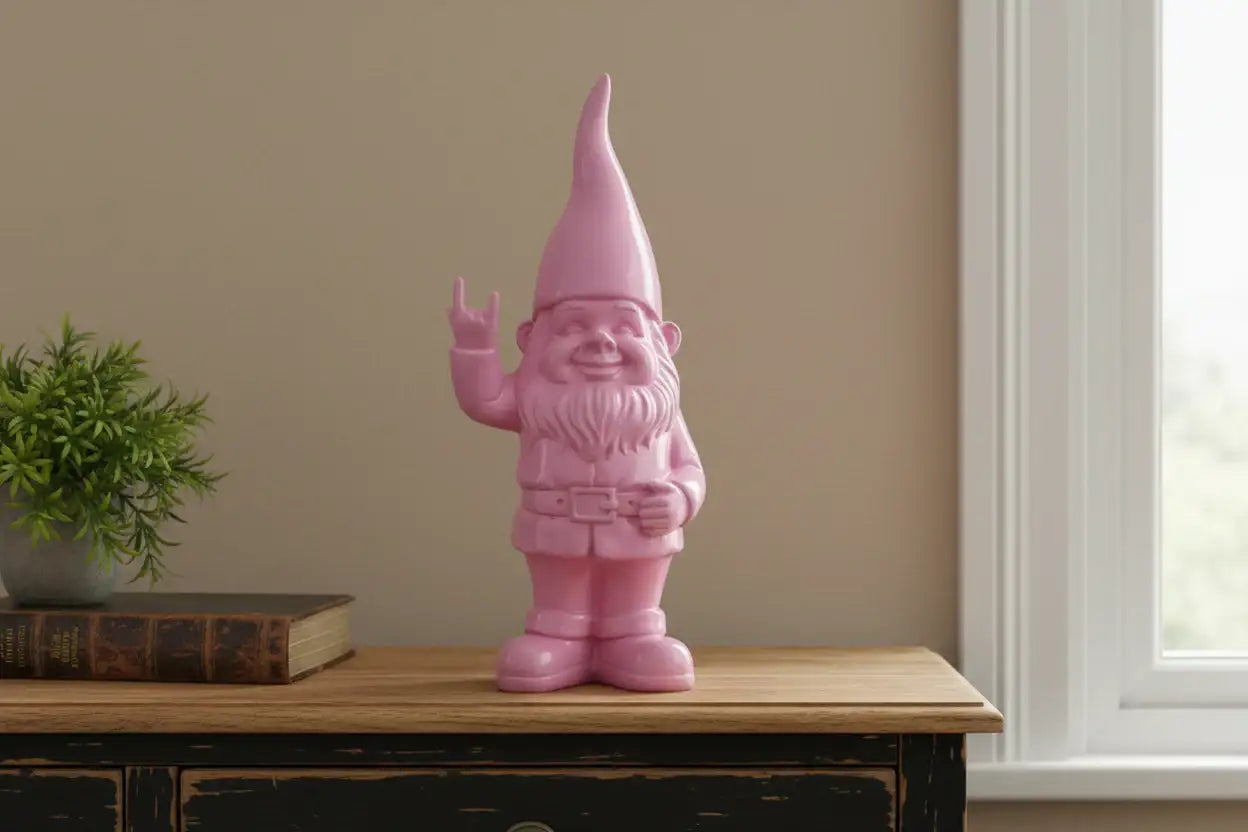 Pink gnome figurine on a wooden surface with a plant and book in the background.