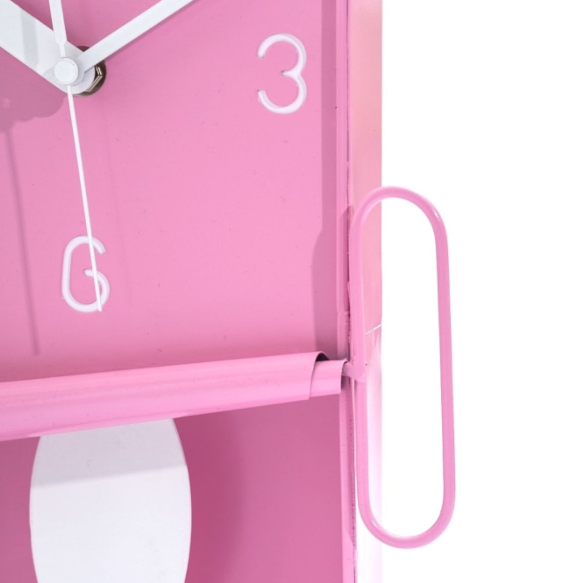 Close-up of a pink clock with a white face on a light pink background