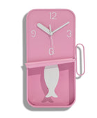Pink wall clock with fish design on a white background