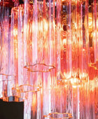 Decorative light fixture with colorful glass tubes on a black background