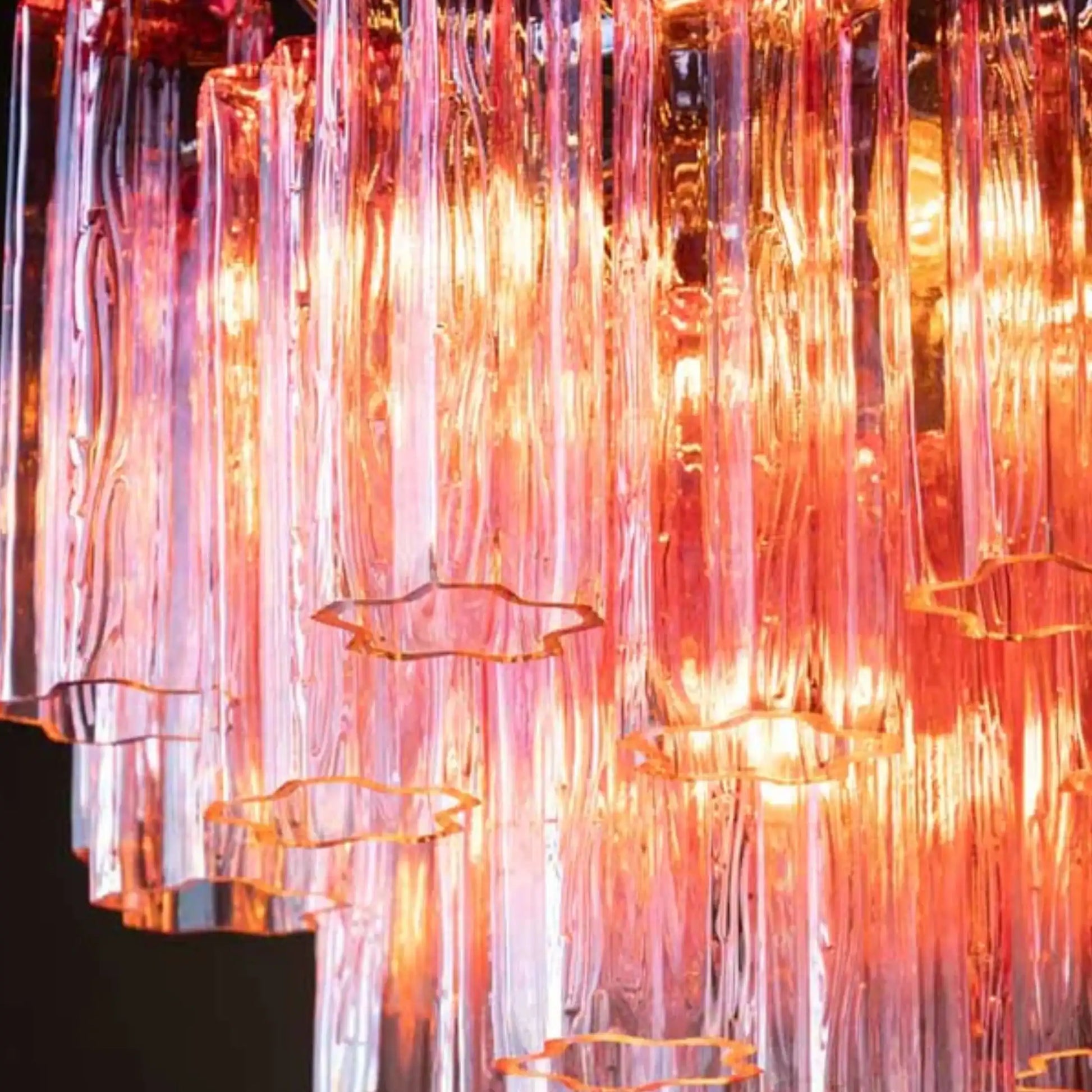 Decorative light fixture with colorful glass tubes on a black background