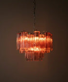 Chandelier with pink glass panels on a dark background