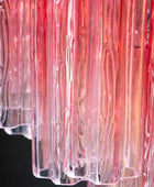 Close-up of a clear plastic container with red and pink gradient on a black background