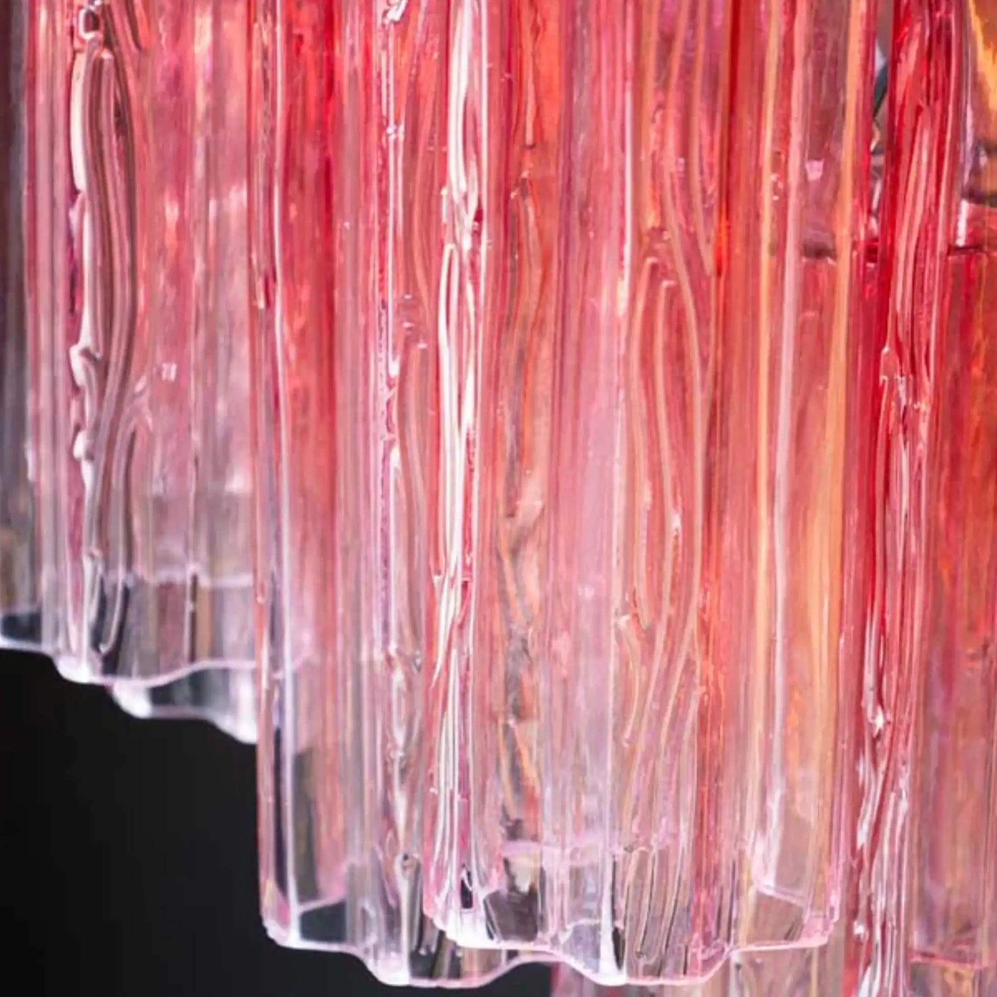 Close-up of a clear plastic container with red and pink gradient on a black background