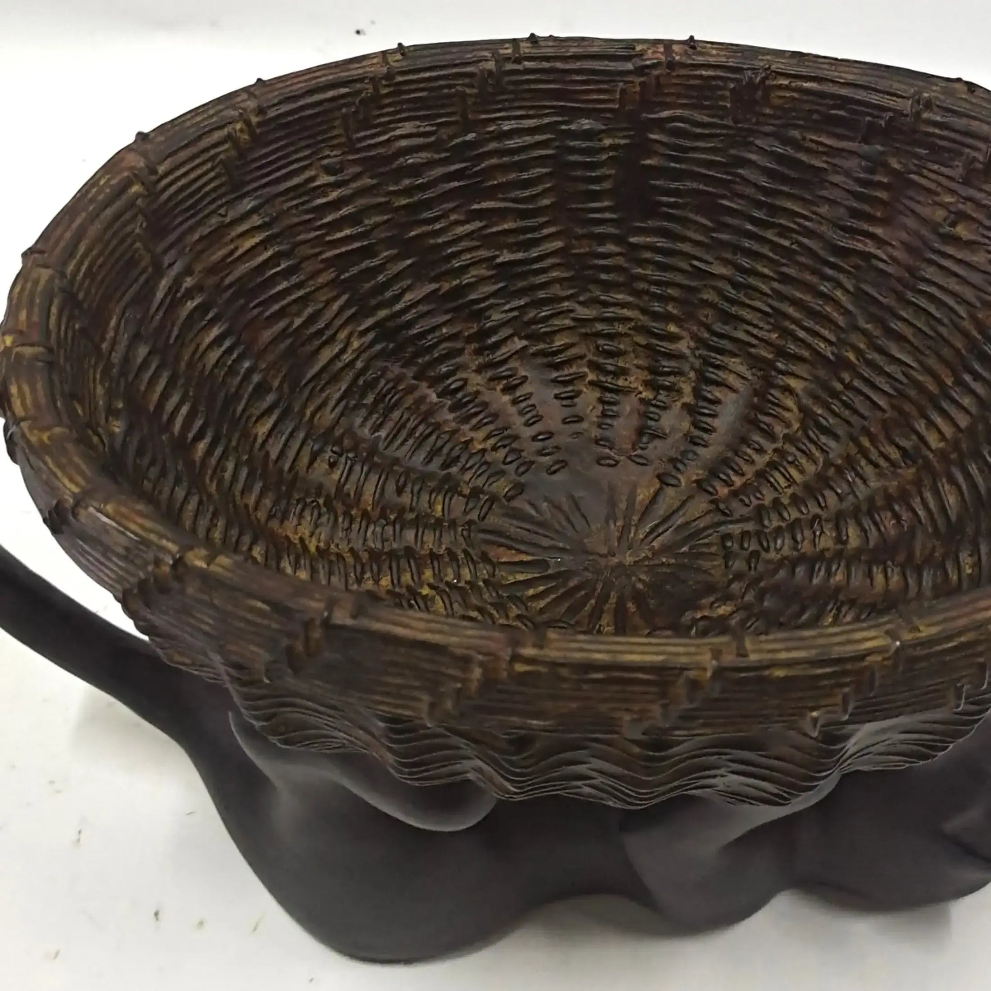 Woven basket with a textured surface on a white background