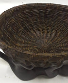 Woven basket with a textured surface on a white background