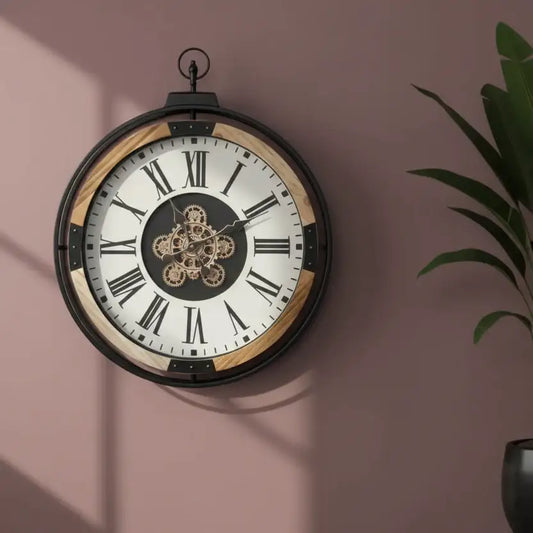 Decorative wall clock with Roman numerals on a pink wall
