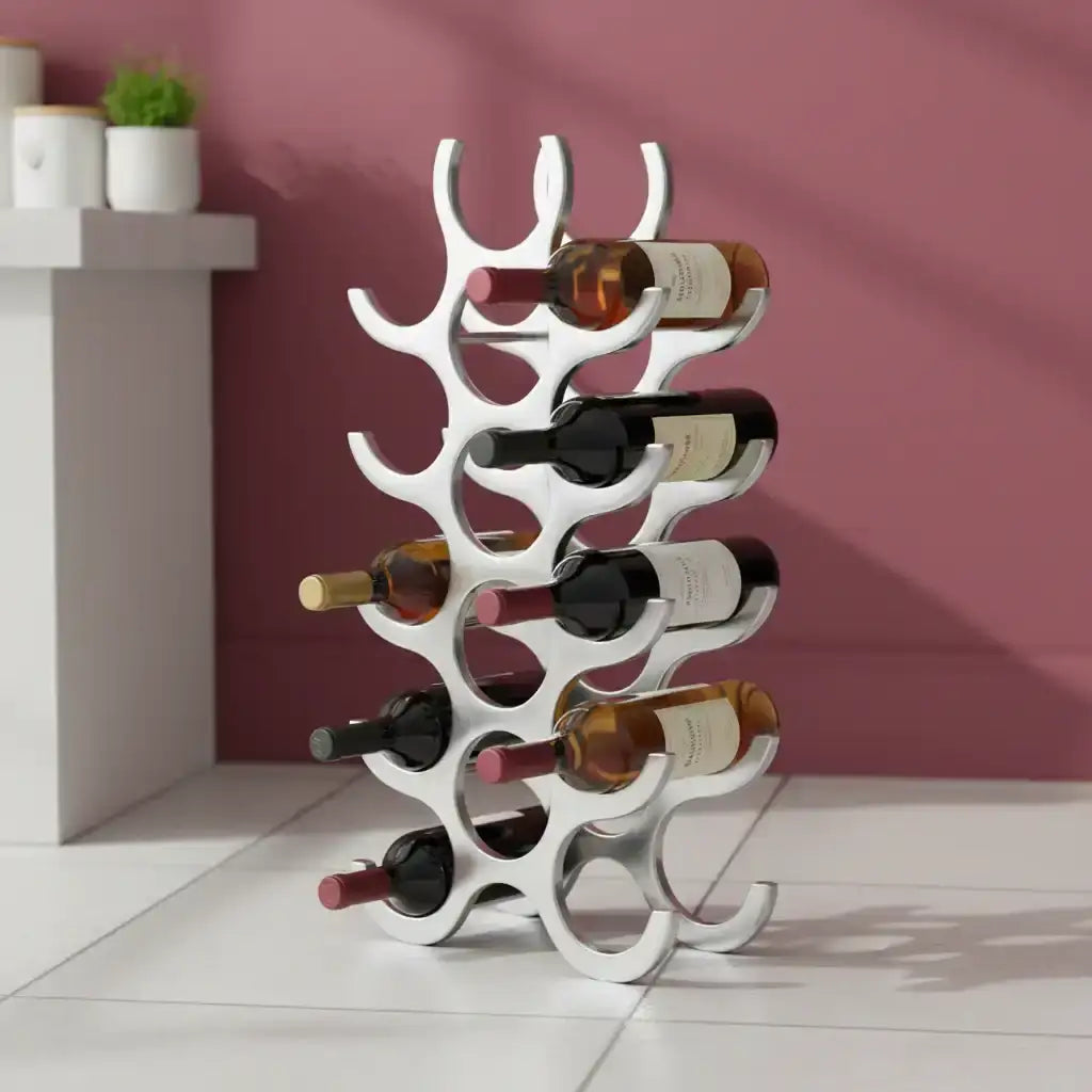 White wine rack holding multiple bottles against a pink wall.