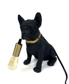 Black dog-shaped lamp with a gold bulb holder on a white background
