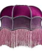 A vintage-style dome-shaped velvet headpiece or hat with a magenta top, purple panels, and a long fringed bottom, shown against a plain white background.