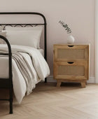 Bedroom with black metal bed frame, white bedding, and wooden nightstand.