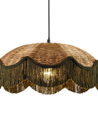A bohemian-style pendant light with a woven wicker shade, bronze metal fringe, and a central glowing bulb, suspended by a black cord against a white background.