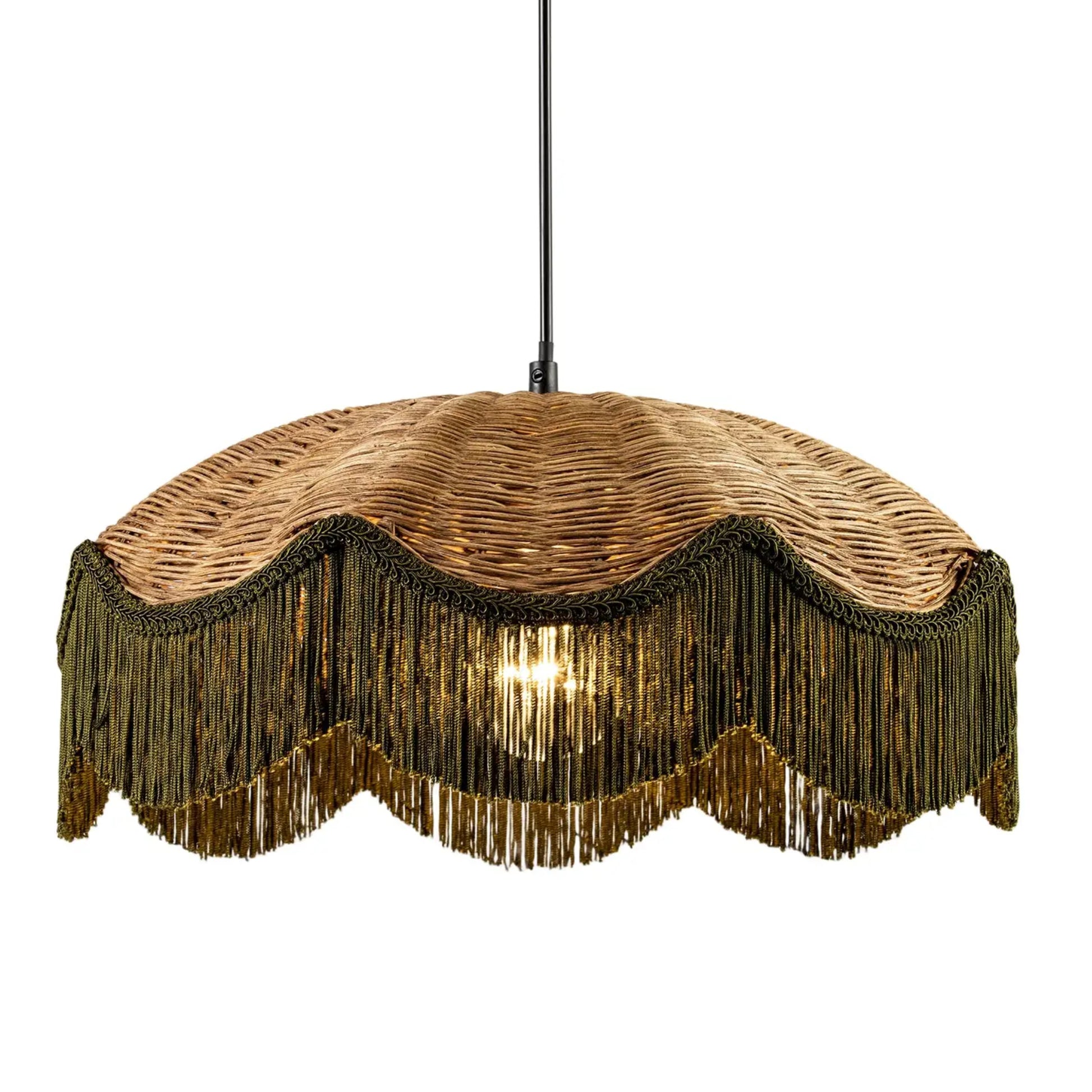 A bohemian-style pendant light with a woven wicker shade, bronze metal fringe, and a central glowing bulb, suspended by a black cord against a white background.