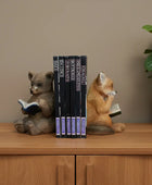 Two animal figurines reading books on a wooden surface with a rustic background.