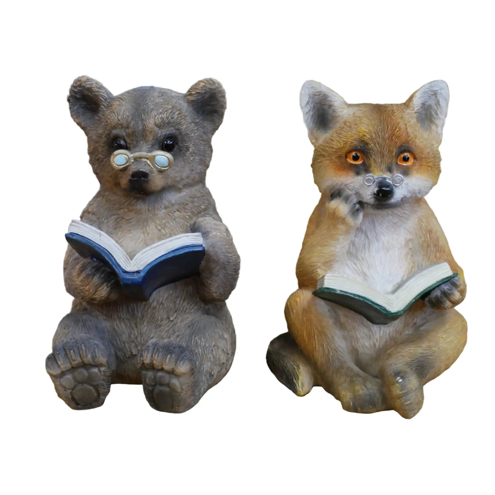 Two animal figurines, a bear and a fox, reading books on a wooden surface.