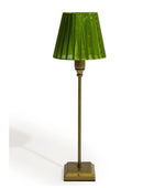 Green lamp with a brass base on a white background