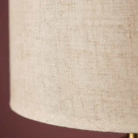Close-up of a textured beige lampshade on a dark background