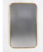 Rectangular mirror with gold frame on a white wall