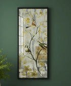 Framed artwork on a green wall with a plant in the corner