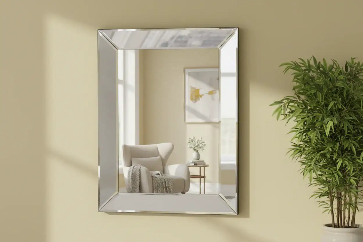 Rectangular mirror on a beige wall with a chair and plant in the reflection