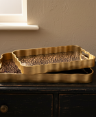 Gold tray with leopard print on a dark surface