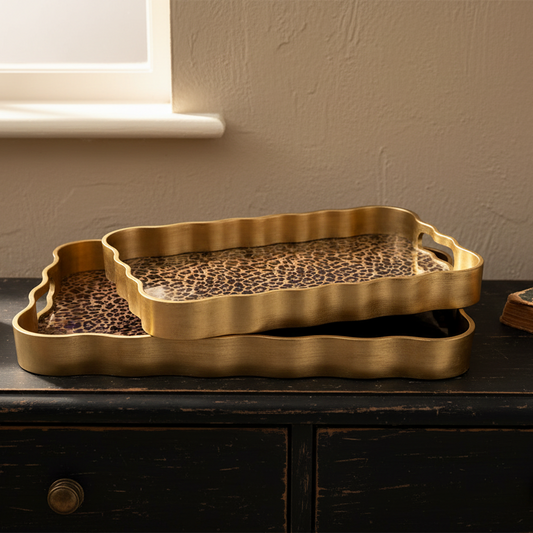 Gold tray with leopard print on a dark surface