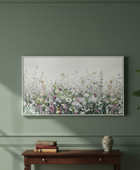 Decorative interior with a floral painting, wooden console table, and plant against a green wall.