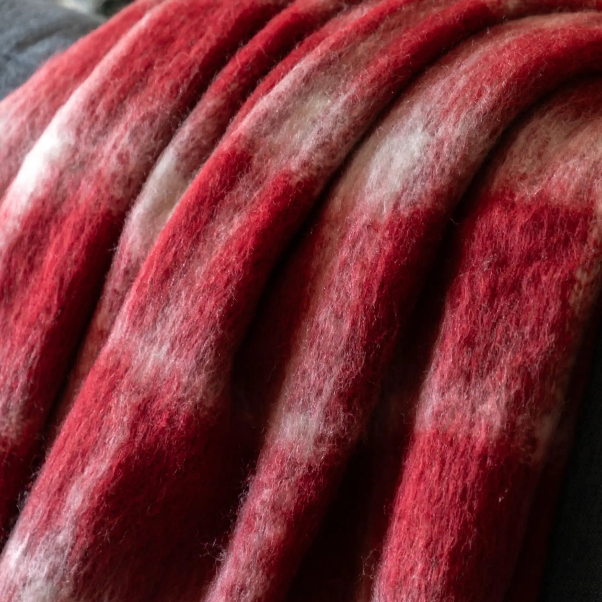 Close-up of red and gray wool fibers