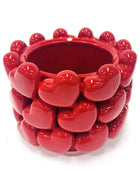 Red ceramic planter with heart designs on a white background