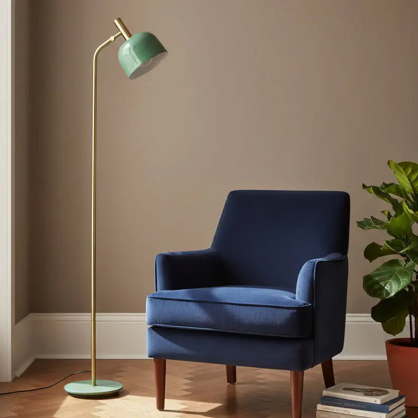 Blue armchair with a green floor lamp against a beige wall
